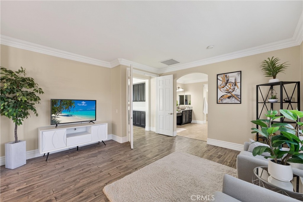 2634 Old Windmill Court Riverside, CA 92503 - Photo 30 of 44 a living room with furniture a potted plant and a flat screen tv