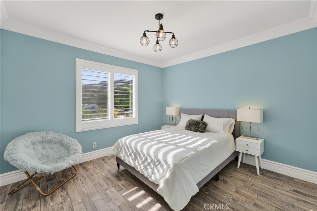 2634 Old Windmill Court Riverside, CA 92503 - Photo 34 of 44 a bedroom with a bed and a chandelier