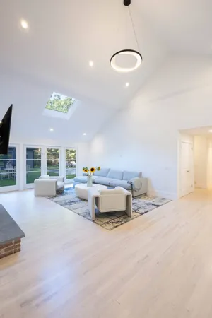 a large kitchen with cabinets a sink and chairs