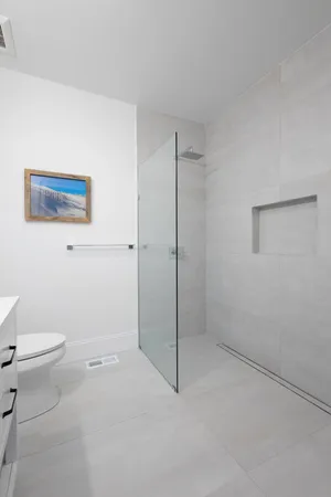 a bathroom with a sink toilet a mirror and vanity
