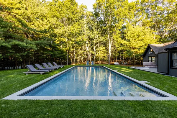 a view of a house with swimming pool and porch