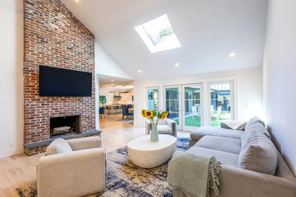 a living room with furniture and floor to ceiling window