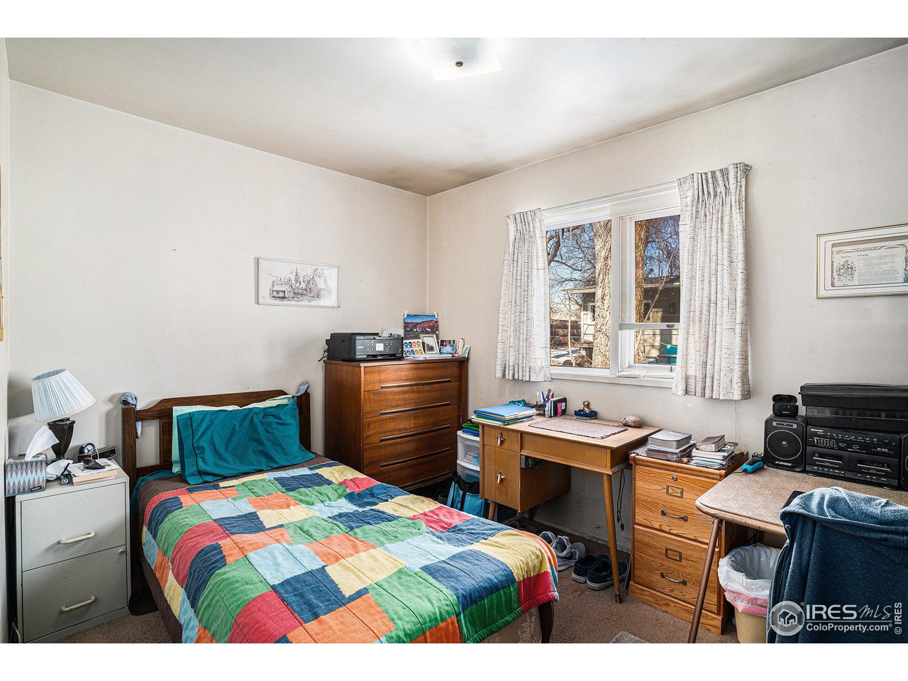 1031 Castlerock Drive Fort Collins, CO 80521 - Photo 13 of 15 a bedroom with a bed and a dresser in it