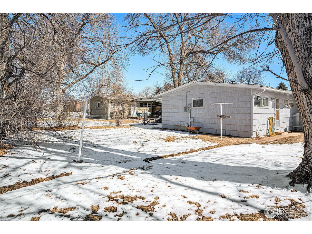 1031 Castlerock Drive Fort Collins, CO 80521 - Photo 3 of 15 a view of a house with snow on the road