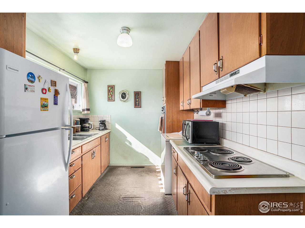 1031 Castlerock Drive Fort Collins, CO 80521 - Photo 10 of 15 a kitchen with granite countertop a stove and a refrigerator