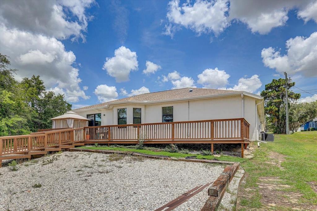 7314 Madrid Road Weeki Wachee, FL 34613 - Photo 33 of 54 a view of a house with a yard