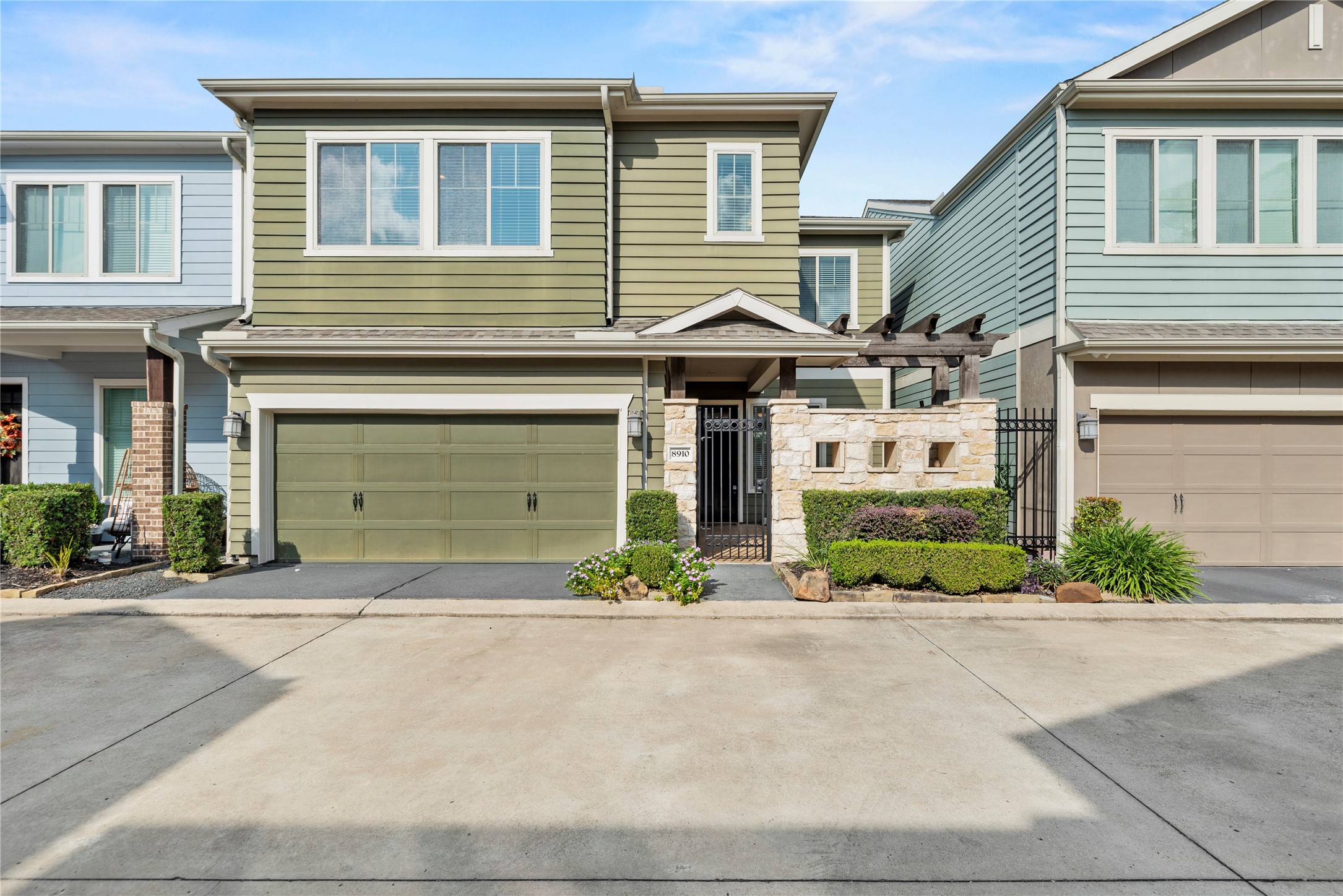 a front view of a house with a yard and a garage