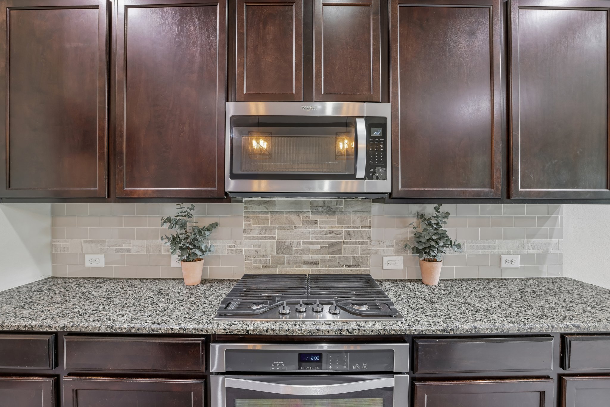 6801 Banff Cove Austin, TX 78754 - Photo 8 of 37 Granite counters and stainless steel appliances with drop-in stovetop elevate this functional and inviting kitchen