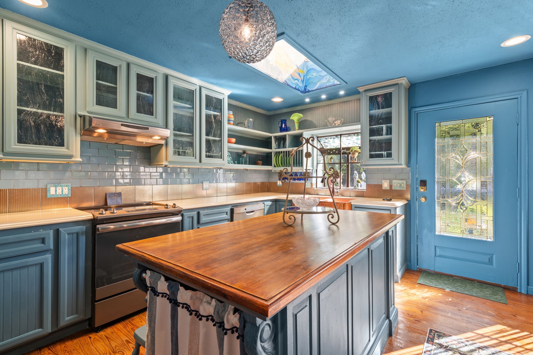 18162 Atkinson Lane Conroe, TX 77384 - Photo 15 of 50 a kitchen with stainless steel appliances granite countertop a sink a stove and a wooden cabinets