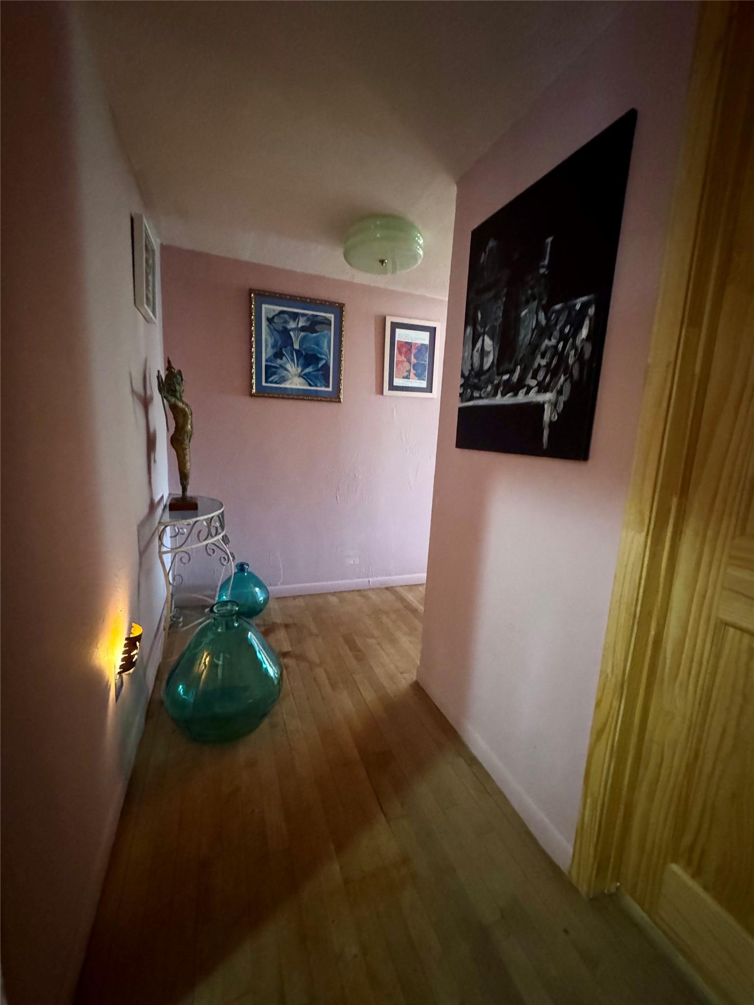 18162 Atkinson Lane Conroe, TX 77384 - Photo 20 of 50 a room with painting on the wall and a potted plant