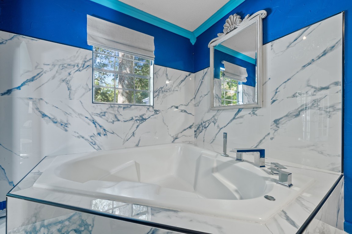 18162 Atkinson Lane Conroe, TX 77384 - Photo 25 of 50 Roomy jet tub with plenty of natural lighting in primary bathroom