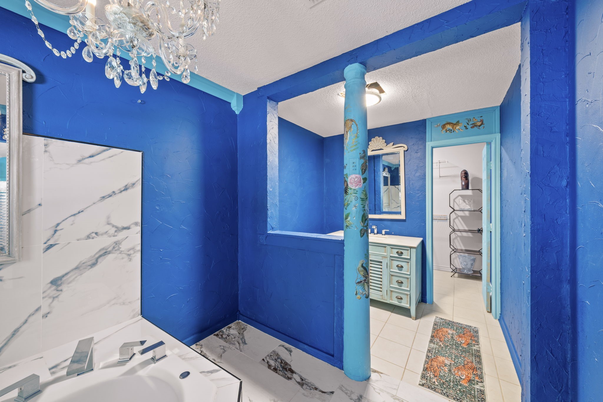 18162 Atkinson Lane Conroe, TX 77384 - Photo 28 of 50 a bedroom with a bed and a chandelier