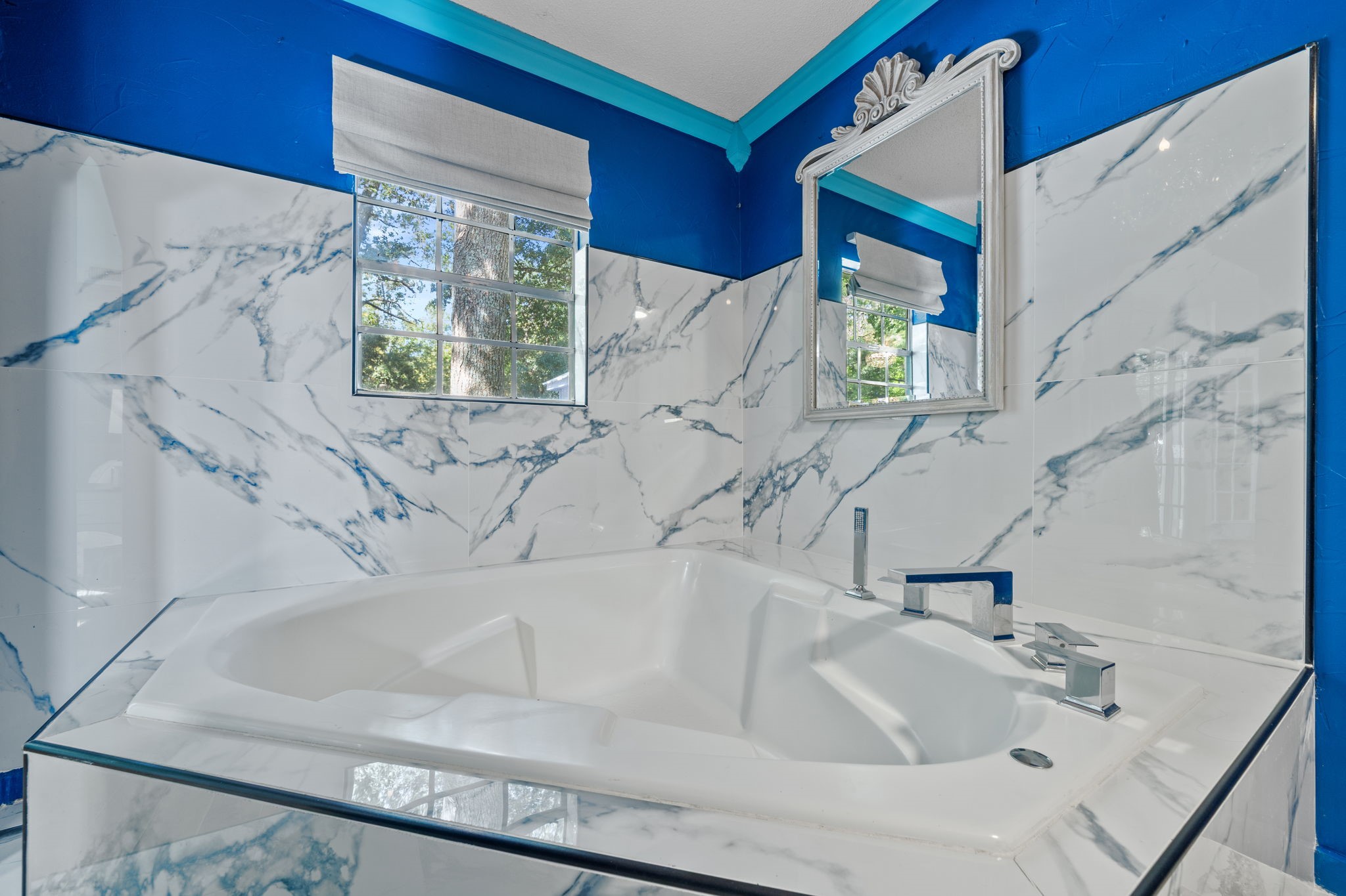18162 Atkinson Lane Conroe, TX 77384 - Photo 29 of 50 a white bath tub sitting next to a white sink and a large window