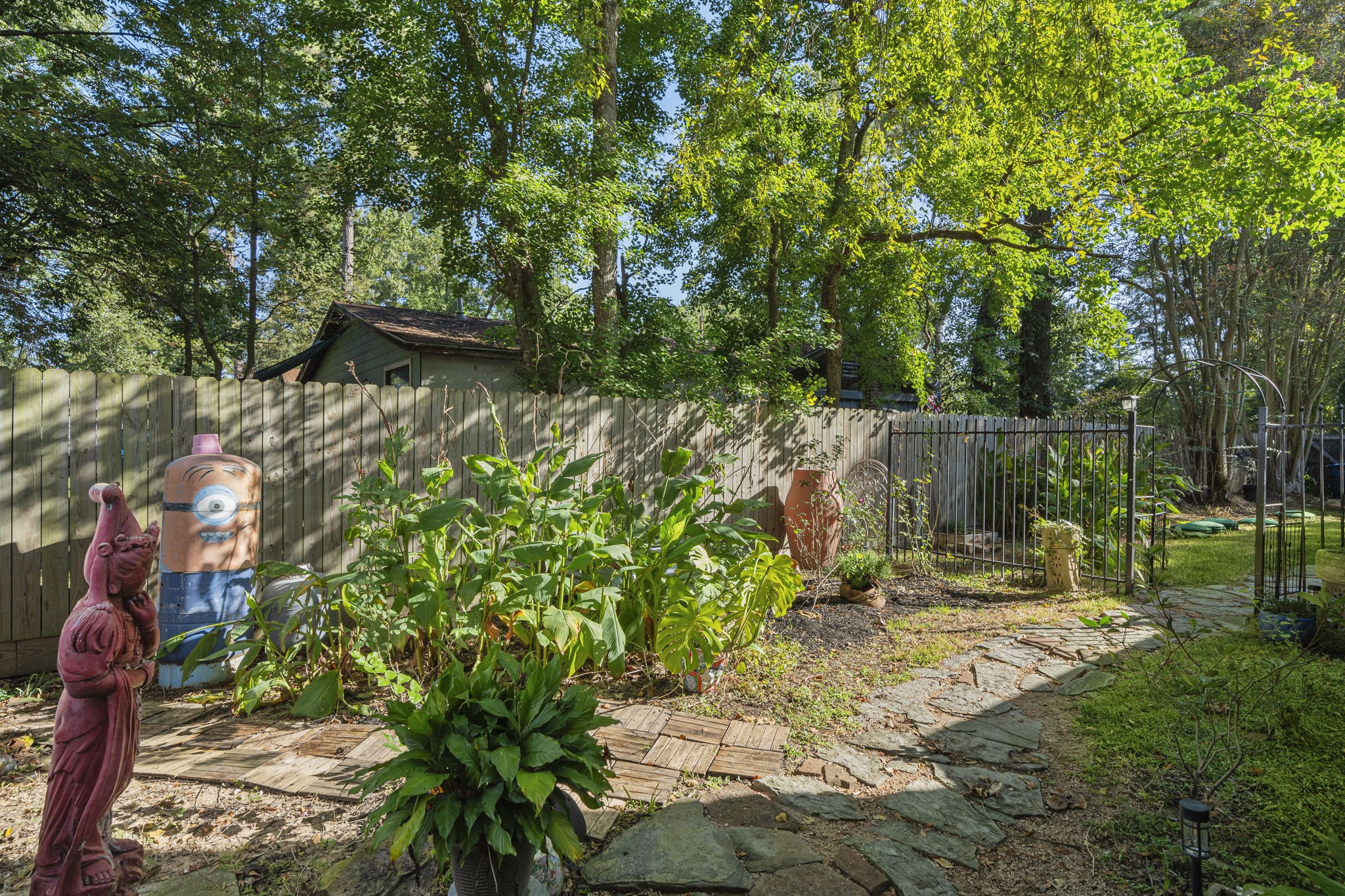 18162 Atkinson Lane Conroe, TX 77384 - Photo 5 of 50 a backyard of a house with table and chairs potted plants and large tree