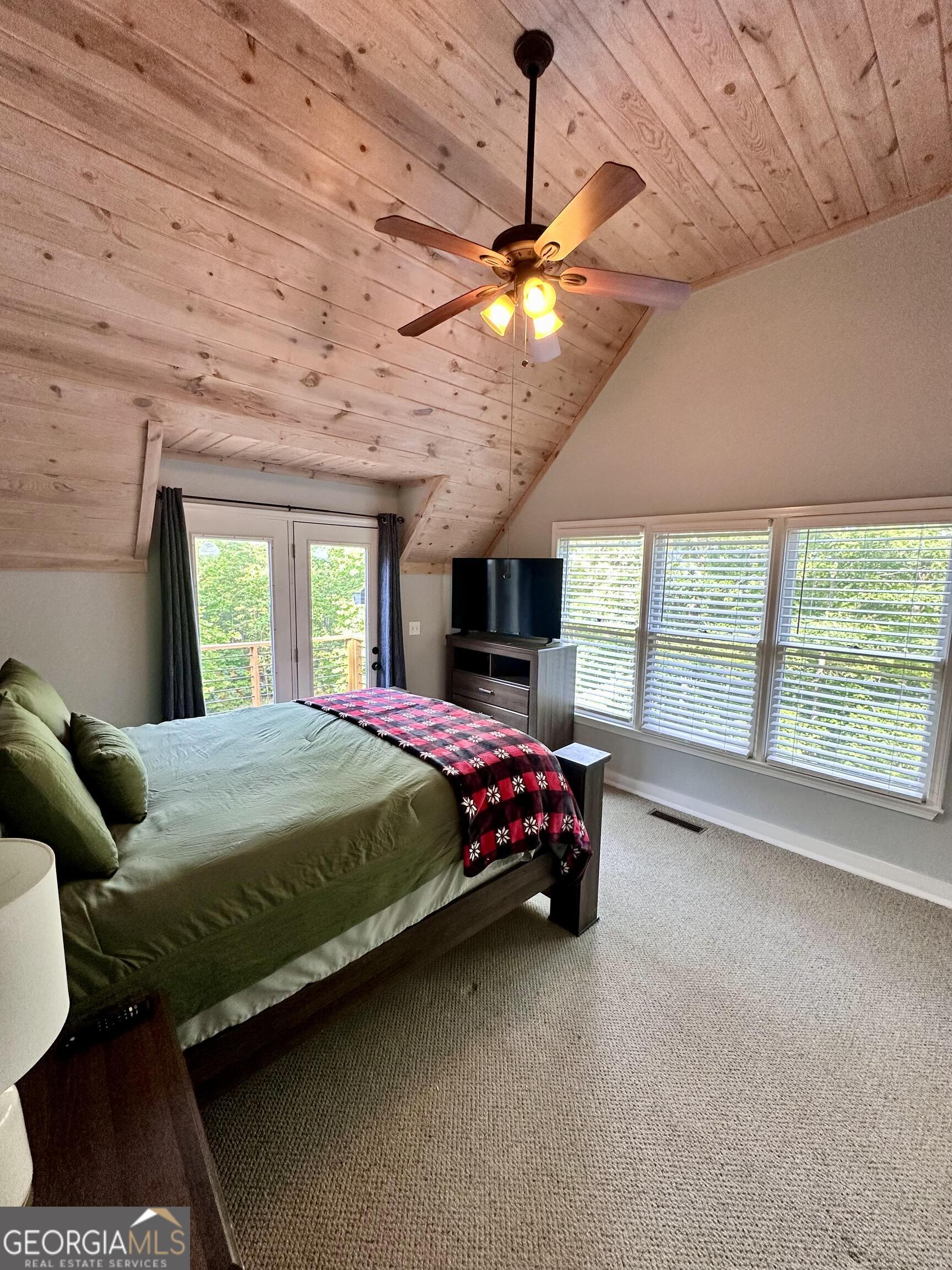 2769 Bean Creek Road Sautee Nacoochee, GA 30571 - Photo 9 of 33 a bed sitting in a spacious bedroom next to a window