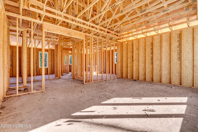 a bathroom with a sink a mirror a potted plant and a shower