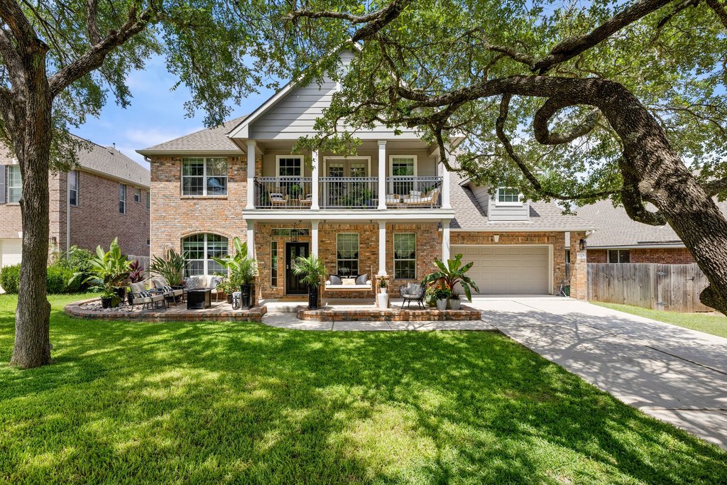 6704 Kiev Cove Austin, TX 78739 - Photo 2 of 37 A classic brick exterior with a welcoming porch and a second-story balcony offers grand curb appeal.