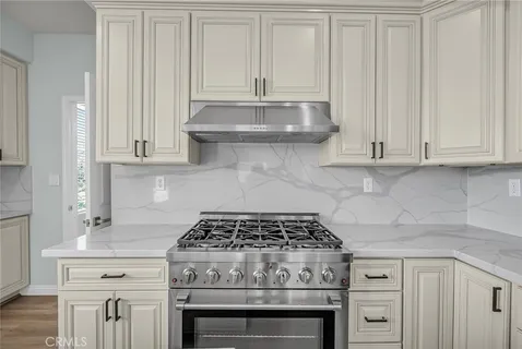 a living room with furniture a fireplace and a potted plant