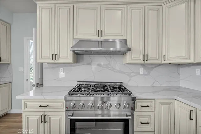 a living room with furniture a fireplace and a potted plant
