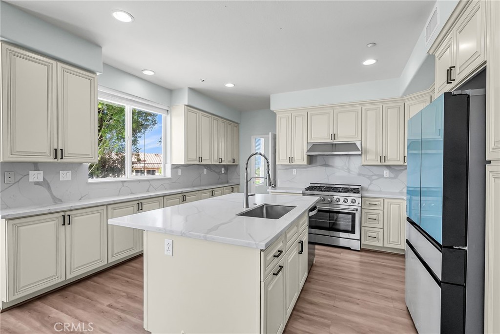 7535 Misty View Place Riverside, CA 92506 - Photo 17 of 75 a kitchen with white cabinets appliances and window