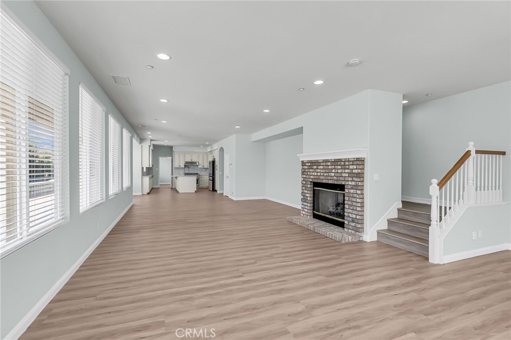 7535 Misty View Place Riverside, CA 92506 - Photo 18 of 75 a view of a livingroom with wooden floor and a fireplace