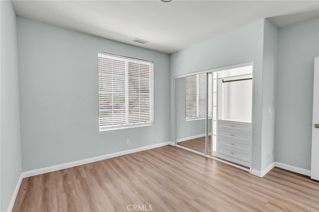 7535 Misty View Place Riverside, CA 92506 - Photo 33 of 75 an empty room with wooden floor and windows