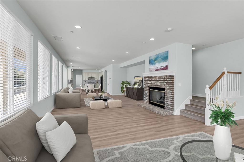 7535 Misty View Place Riverside, CA 92506 - Photo 36 of 75 a living room with furniture a fireplace and a potted plant