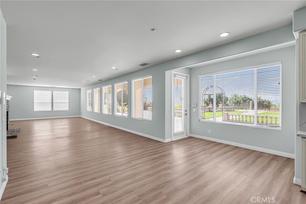 7535 Misty View Place Riverside, CA 92506 - Photo 40 of 75 a view of an empty room with wooden floor and a window