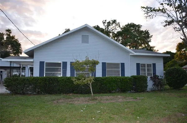 a house that has a tree in front of it