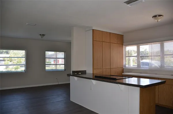 a kitchen with granite countertop a sink a stove and cabinets