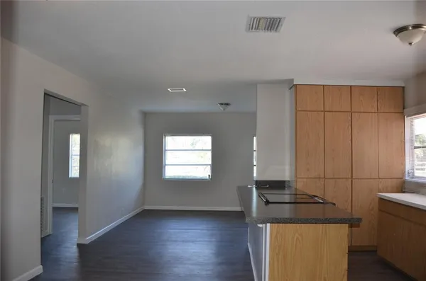a view of wooden floor and windows in a room
