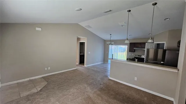 a kitchen with stainless steel appliances a refrigerator and a stove top oven