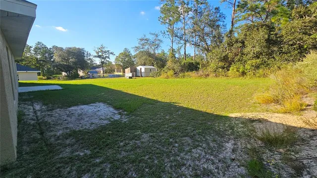 a view of yard with swimming pool and green space