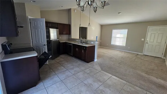 a large kitchen with cabinets and stainless steel appliances