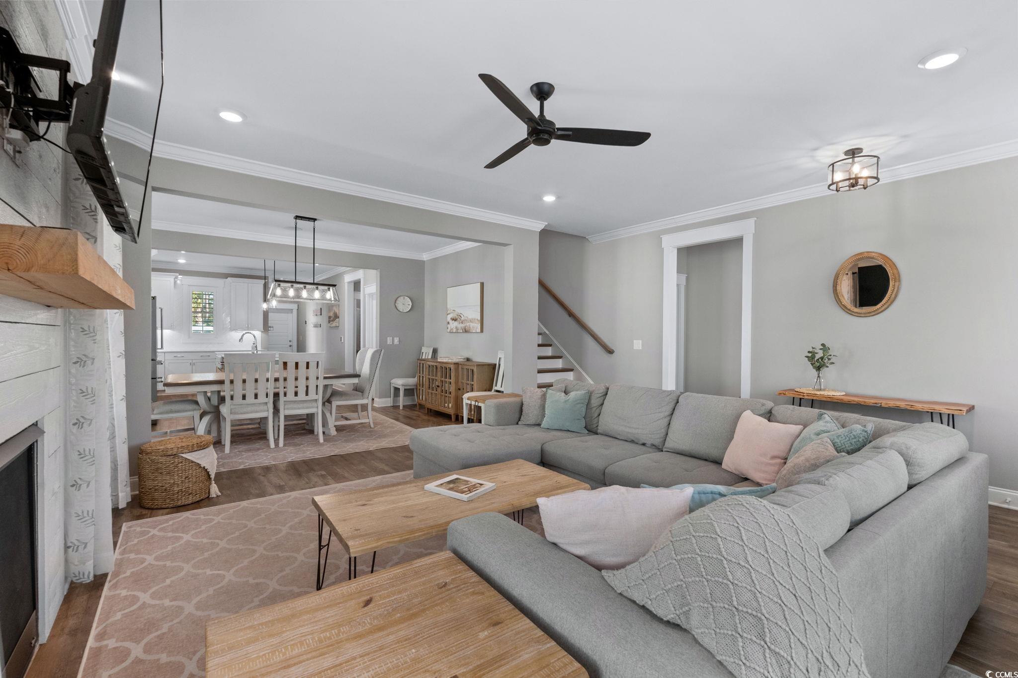 8336 Sandlapper Way Myrtle Beach, SC 29572 - Photo 12 of 40 Living room featuring a fireplace, crown molding, wood finished floors, recessed lighting, and ceiling fan