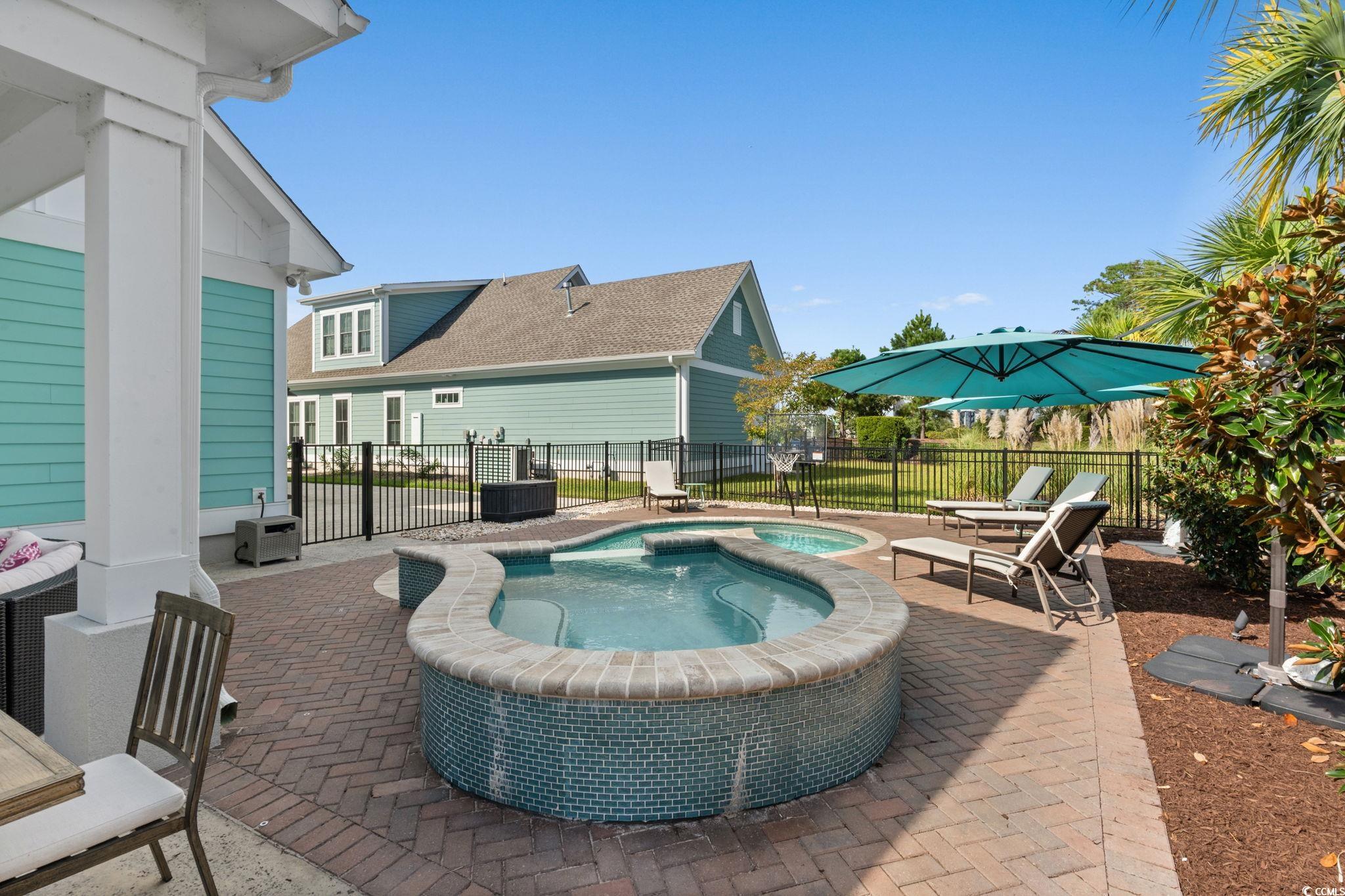 8336 Sandlapper Way Myrtle Beach, SC 29572 - Photo 30 of 40 View of pool featuring a patio and a pool with connected hot tub