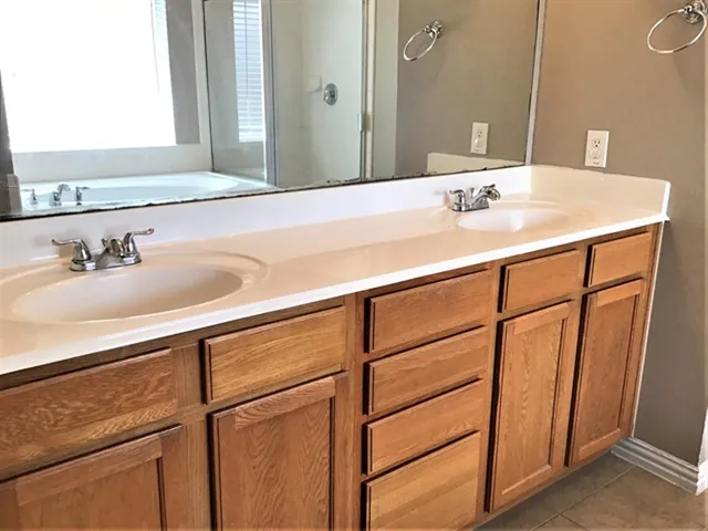 a bath tub sitting in a bathroom next to a window