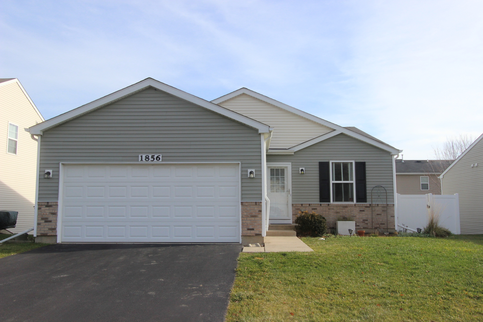 1856 Butterfield Road Woodstock, IL 60098 - Photo 1 of 26 a front view of house with yard and trees around