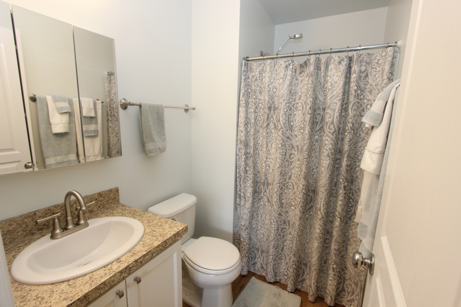 1856 Butterfield Road Woodstock, IL 60098 - Photo 11 of 26 a bathroom with a sink toilet and a mirror