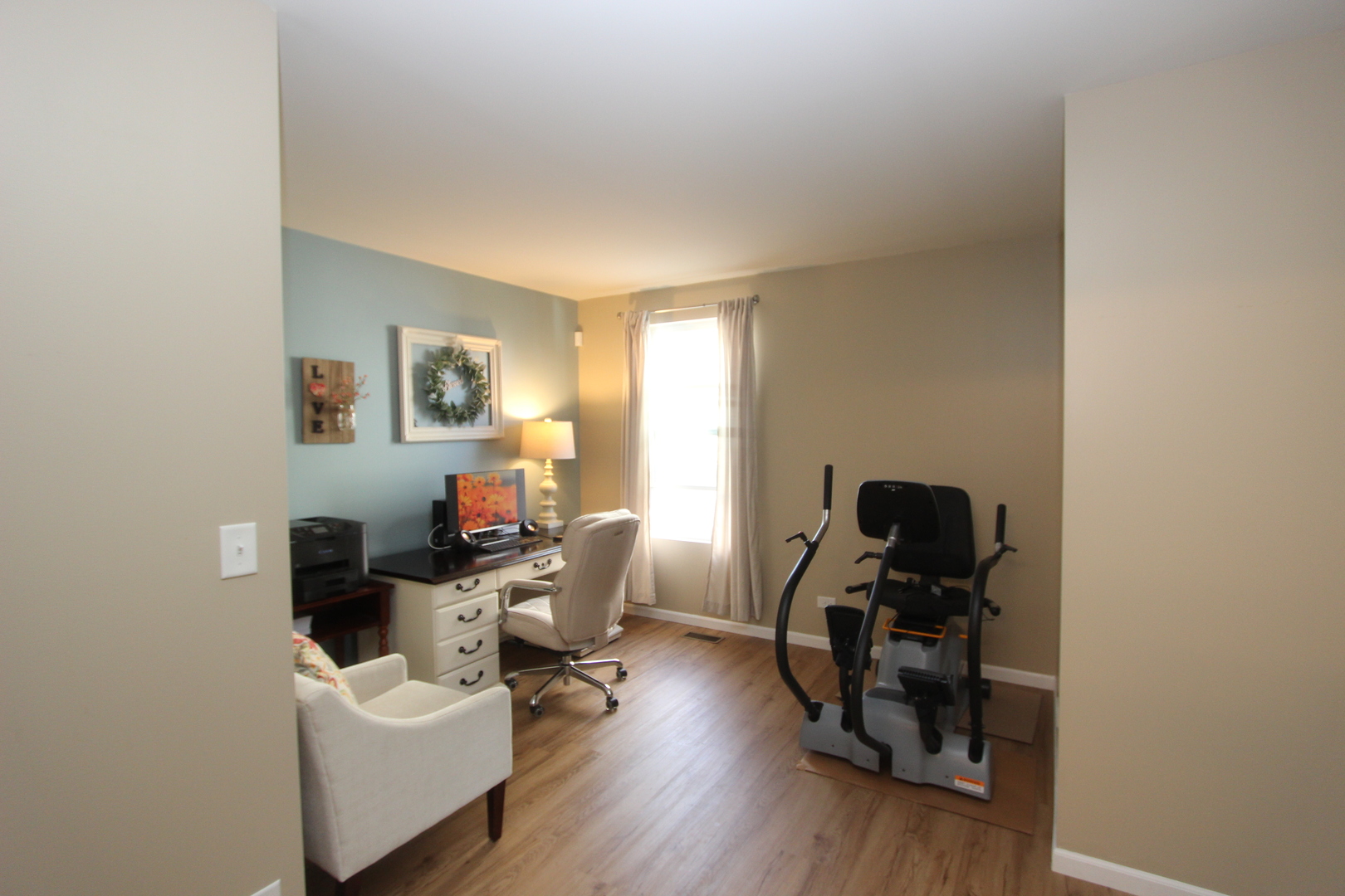 1856 Butterfield Road Woodstock, IL 60098 - Photo 14 of 26 a view of a workspace with furniture and wooden floor