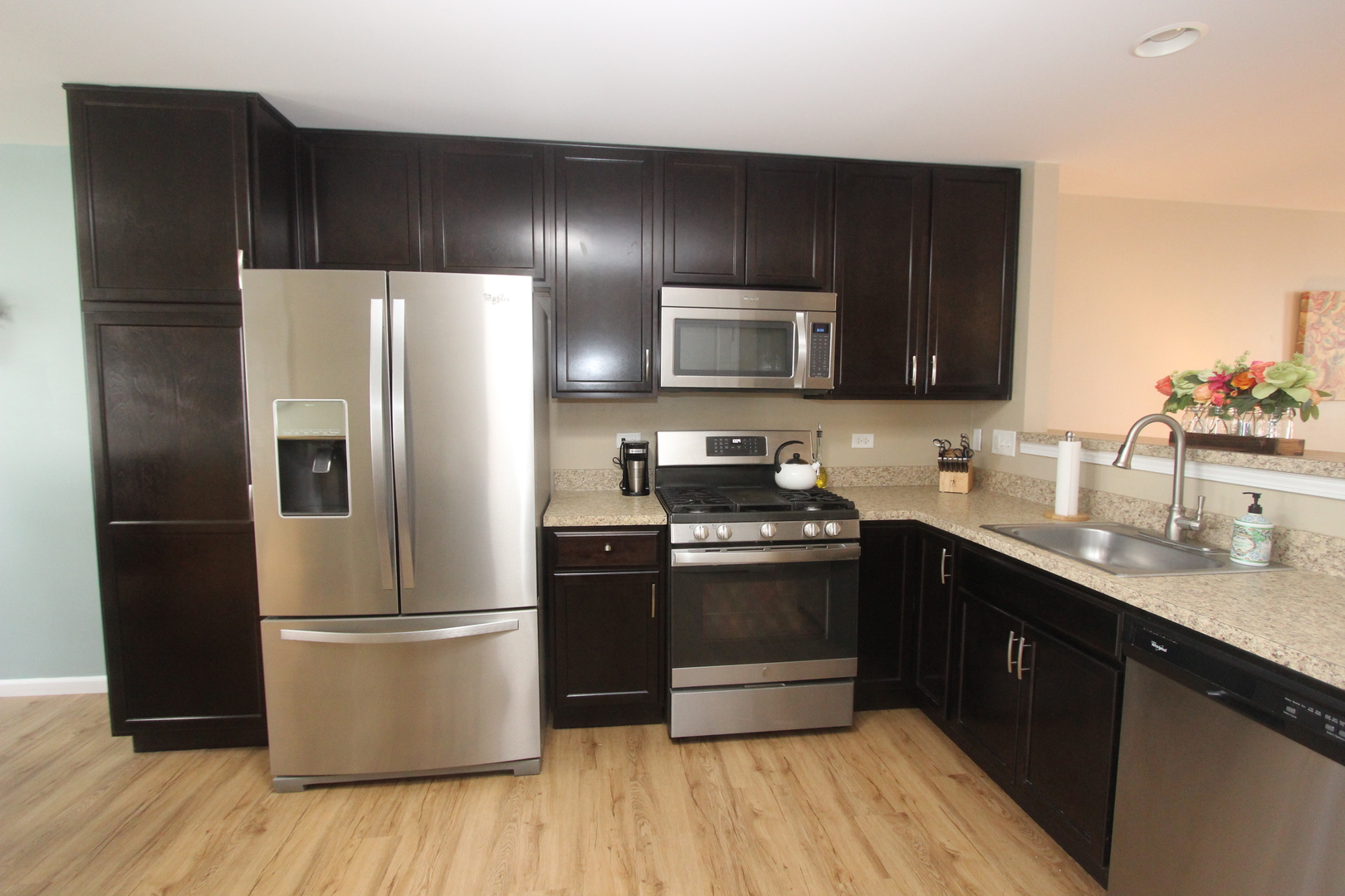 1856 Butterfield Road Woodstock, IL 60098 - Photo 6 of 26 a kitchen with stainless steel appliances wooden cabinets and wooden floor