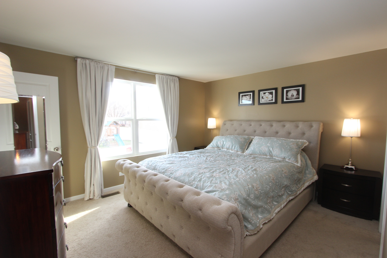 1856 Butterfield Road Woodstock, IL 60098 - Photo 8 of 26 a bedroom with a bed and a window