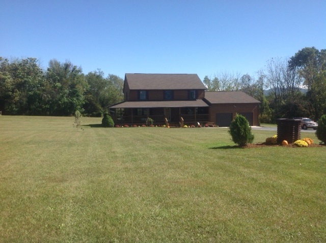 8675 East Timber Ridge Road Mount Crawford, VA 22841 - Photo 3 of 30 a backyard of a house with table and chairs