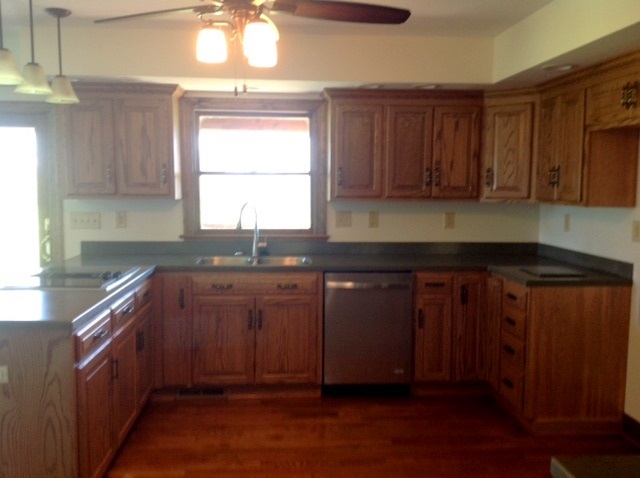8675 East Timber Ridge Road Mount Crawford, VA 22841 - Photo 8 of 30 a kitchen with granite countertop wooden cabinets a sink and a window