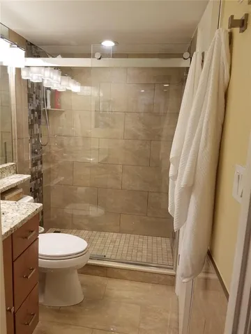 a bathroom with a shower and a toilet