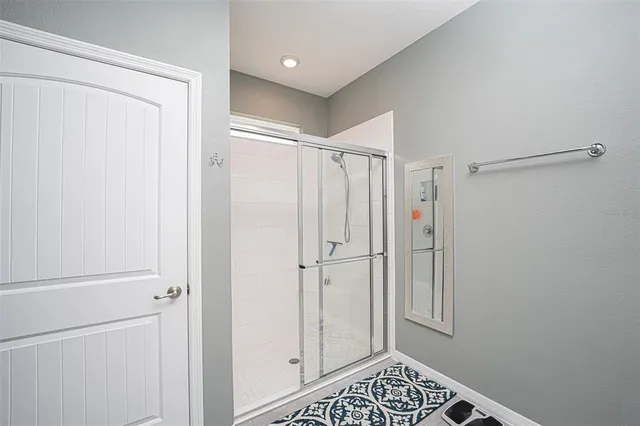 a bathroom with a shower and a sink