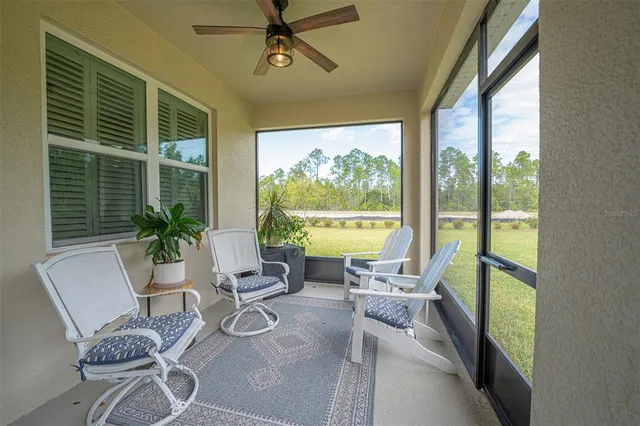a view of a livingroom with furniture and floor to ceiling window