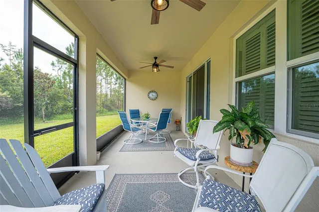 a living room with furniture floor to ceiling window and wooden floor