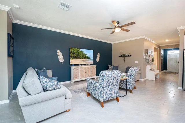 a living room with furniture and a chandelier