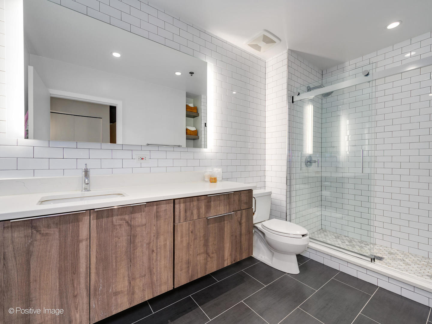 203 South Sangamon Street, Unit 213 Chicago, IL 60607 - Photo 15 of 23 a bathroom with a double vanity sink toilet and shower
